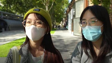 Young women in Beijing talk to a BBC journalist