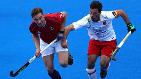 Harry Martin of Great Britain and Miguel Delas of Spain challenge each other for the ball during a hockey match