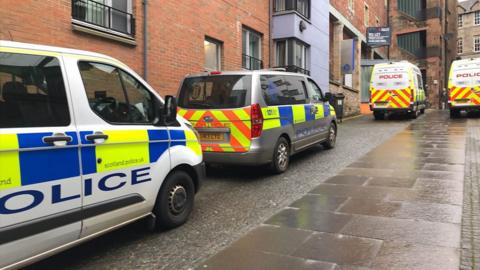 Several police vehicles were seen parked outside the party's headquarters in Edinburgh this morning.