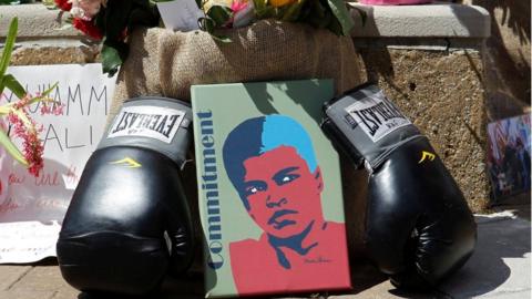Fans of Muhammad Ali, the former world heavyweight boxing champion, leave pictures and personal mementos as they pay their respects at the Ali Center in Louisville, Kentucky, U.S. June 7, 2016
