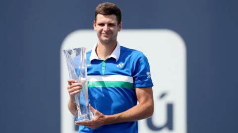 Poland's Hubert Hurkacz smiles as he holds up the Miami Open trophy after beating Jannik Sinner in the men's singles final