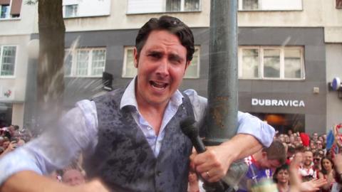 Croatian football fans give BBC reporter a beer shower