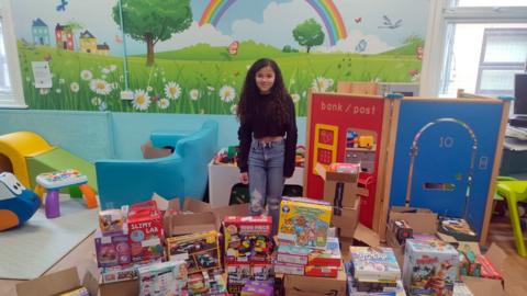 Rhea Oke with the toys that were donated