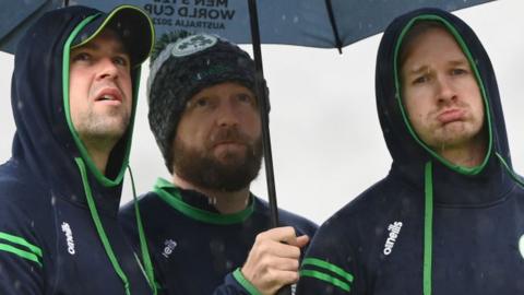 Ireland players shelter from the rain