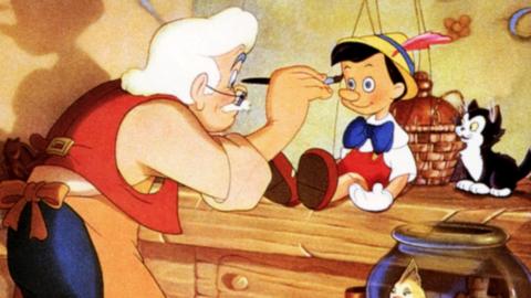A still from the 1940 Disney movie Pinocchio. Gepetto is painting Pinocchio's face. It is a beautiful, vibrant, rich, classic hand-drawn animation.