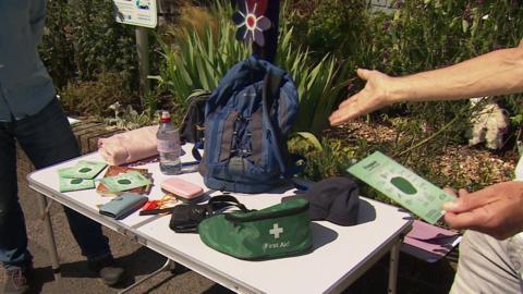 Emergency items displayed on a table including first aid kit.