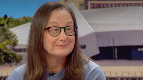 Julie Maughan, a woman with brown hair and glasses