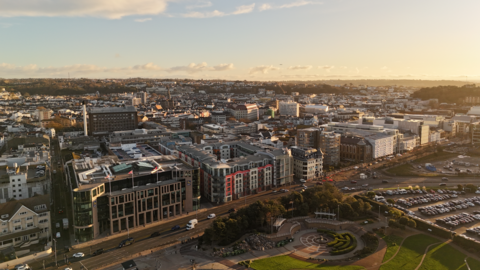A picture taken from above looking down on Jersey. There is a sunset and a number of large properties.