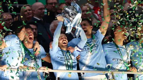 Bernardo Silva lifts the trophy