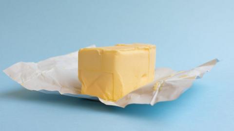 block of butter on a blue background 