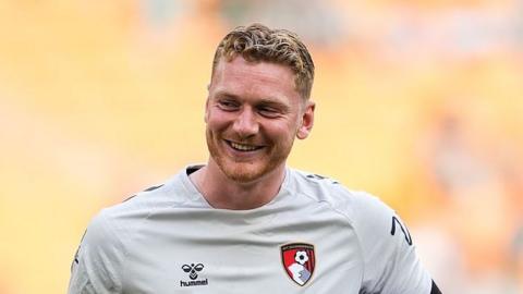 Will Dennis smiling while in action for Bournemouth