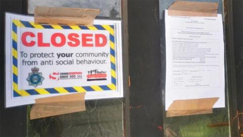 A police sign on a house door in East Yorkshire saying "Closed to protect your community from anti social behaviour"