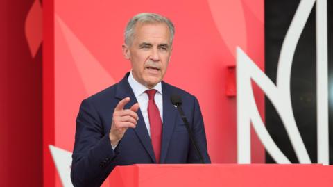 Prime Minister Mark Carney speaking during a Canada Day event