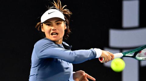 Emma Raducanu hits a forehand