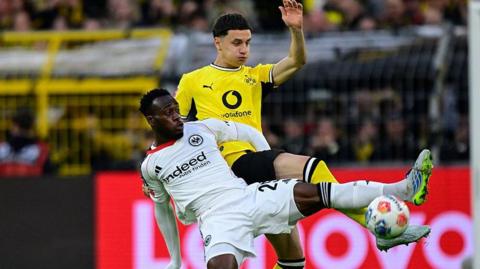 Frankfurt's French forward Arnaud Kalimuendo and Dortmund's Italian defender Luca Reggiani