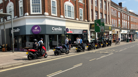 Epsom High Street, motorcycles on the pavement, McDonalds, Papa Johns