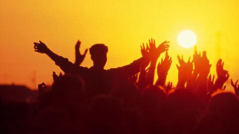 Glastonbury crowd at sunset