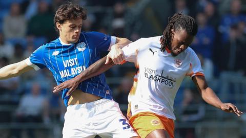 Perry Ng (left) of Cardiff City and Karoy Anderson of Blackpool compete for the ball