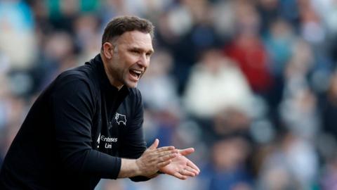 John Eustace claps his Derby County team on from the touchline