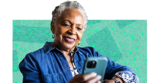 A lady looks at her phone smiling