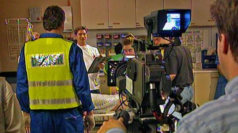 Cast members on set filming an episode of medical drama Casualty.