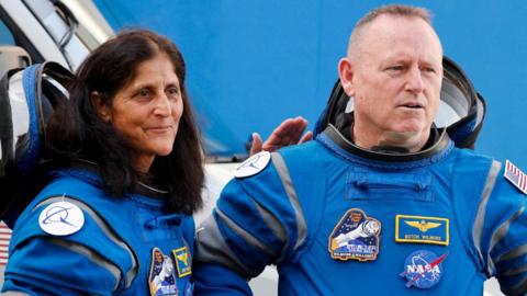 Nasa astronauts Suni Williams and Butch Wilmore in blue flight suits at the Kennedy Space Center