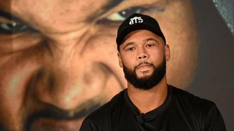 Frazer Clarke looks into the distance during his news conference with Jeamie TKV