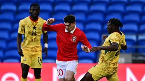 Wales' Dan James runs with the ball
