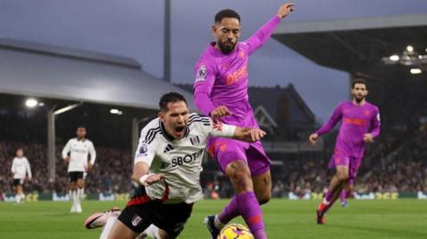 Sasa Lukic goes down under Matheus Cunha's challenge in Fulham's Premier League game against Wolves