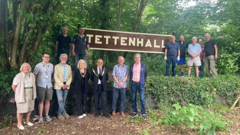 Volunteers and the Mayor of Wolverhampton standing in front of the Tettenhall sign