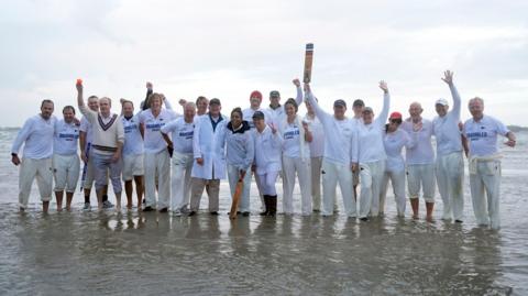 Members of the Royal Southern Yacht Club and the Island Sailing Club take part in the annual Brambles cricket match on the Bramble Bank sandbank in the middle of the Solent at low tide.
