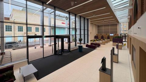 A picture of Reading's Civic Centre, a municipal building with facilities with large glass windows at its entrance.