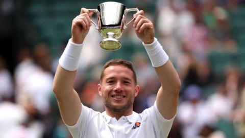 Alfie Hewett lifting the Wimbledon men's singles wheelchair tennis trophy