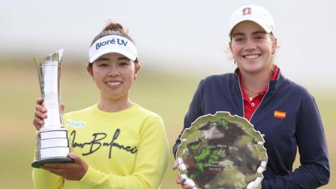 Miyu Yamashita, the winner, and leading amateur Paula Martin Sampedro pose with their trophies on day four of the 2025 AIG Women's Open at Royal Porthcawl