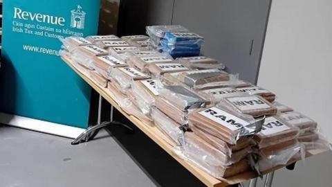 Around 133kg of cocaine stacked up on a table in brown packets