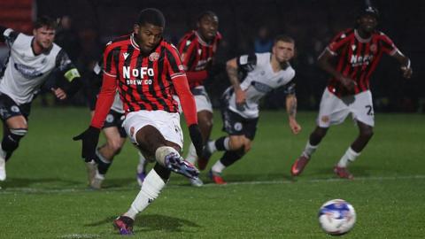 Daniel Kanu puts Walsall ahead from the penalty spot at Gateshead