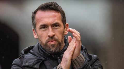 Christian Fuchs applauds fans during Newport's win over Chesterfield
