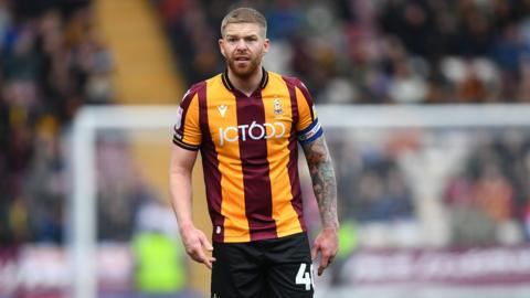 Adam Clayton captaining Bradford City towards the end of his playing career in 2023.