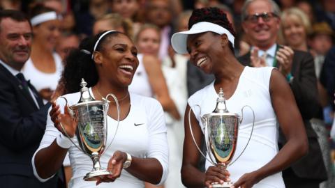 Serena and Venus Williams with the Wimbledon doubles trophies in 2016