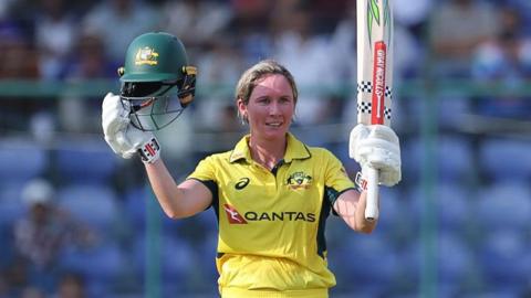 Beth Mooney of Australia raises her bat