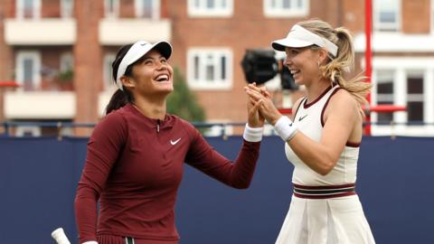 Emma Raducanu and Katie Boulter celebrate a point in their Queen's doubles match