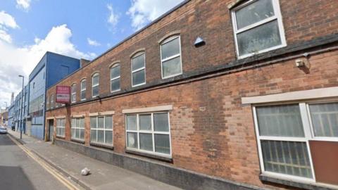 A generic image of Cliveland Street showing a blue building on the far left and another smaller building on the right. 