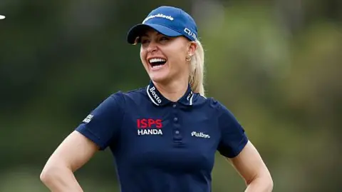 Charley Hull laughs on the course
