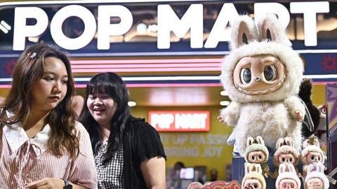 People look at collectable designer art toy Labubu at a Pop Mart pop-up store in Siam Center shopping mall in Bangkok on 6 May, 2025. 