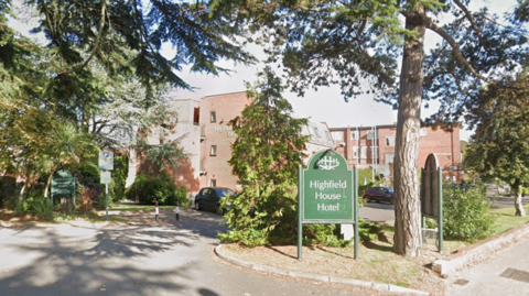 Google street view of the outside of the hotel, including a green sign which reads Highfield House Hotel.