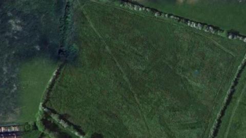 Google satellite image of green fields where the proposed development could be built