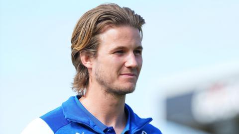 Tommy Leigh walking into the stadium before a match wearing Bristol Rovers clothing
