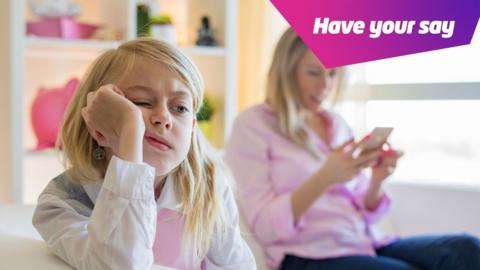 girl looking bored whilst parent is on phone