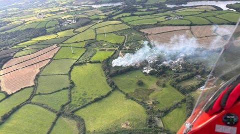 Aerial photo of fire at Penryn as smoke billow across numerous fields.