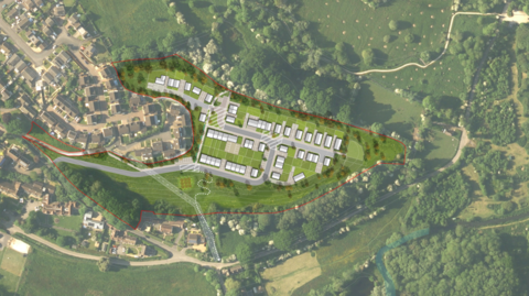 An aerial image of several homes near trees and homes